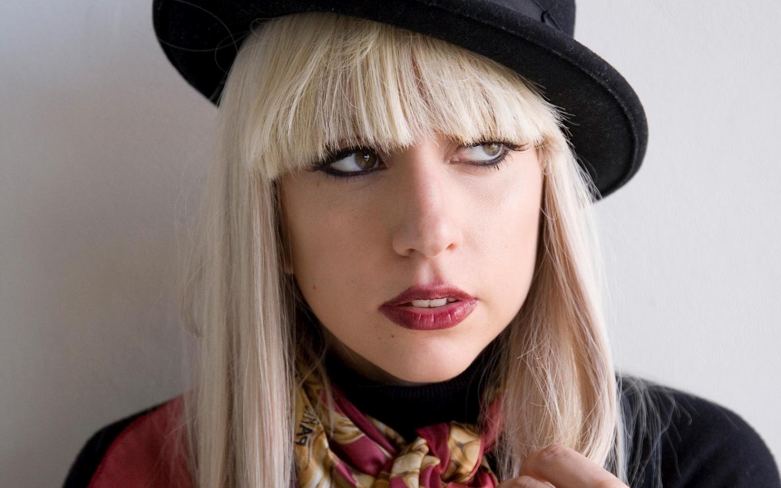 Lady Gaga wearing a top hat and the scarf