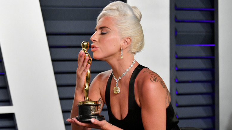 Lady Gaga kissing her award